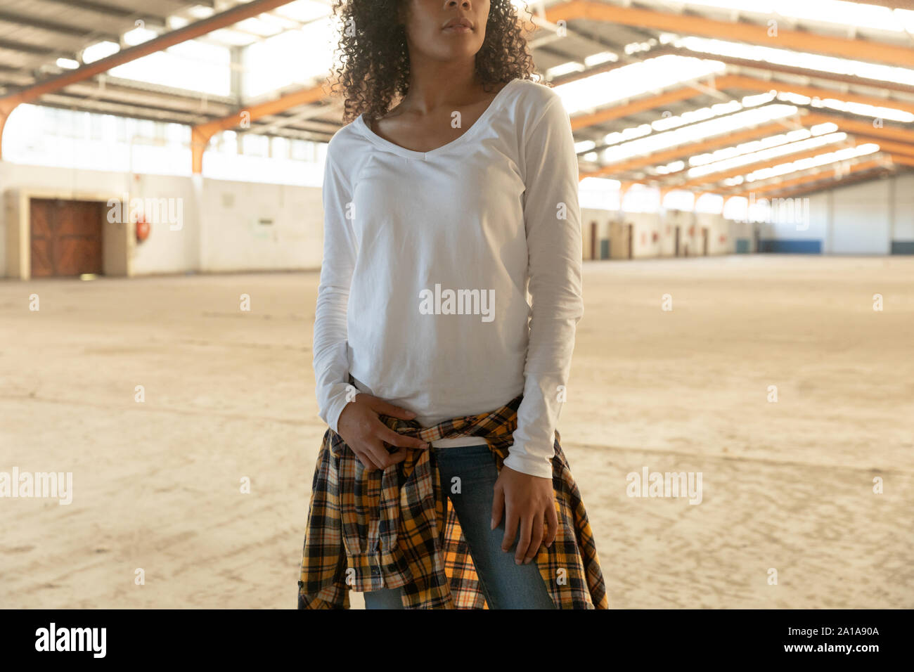 Female dancer in an empty warehouse Stock Photo