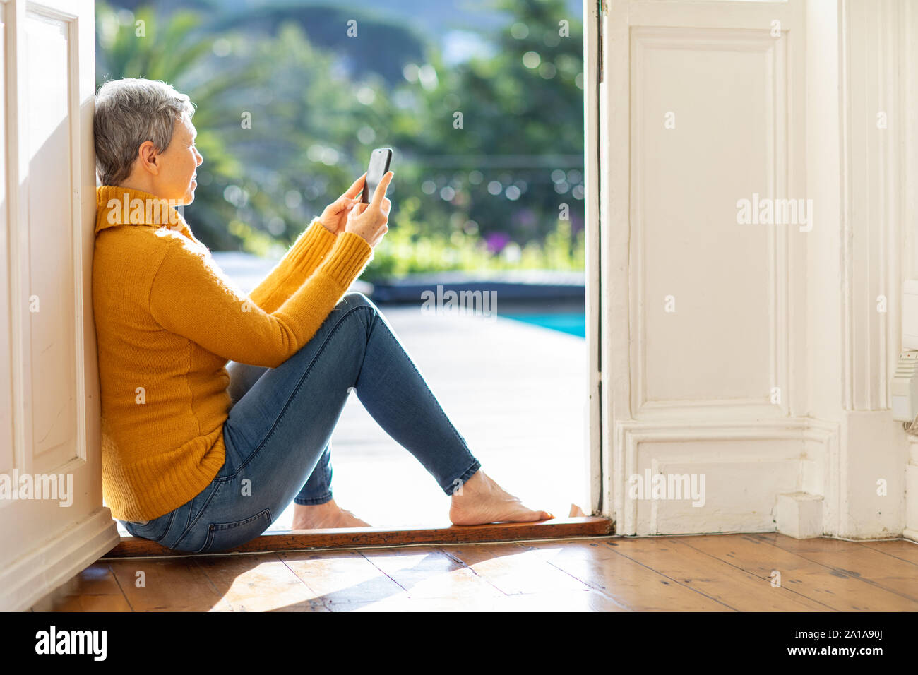 Mature woman thinking at home hi-res stock photography and images - Alamy