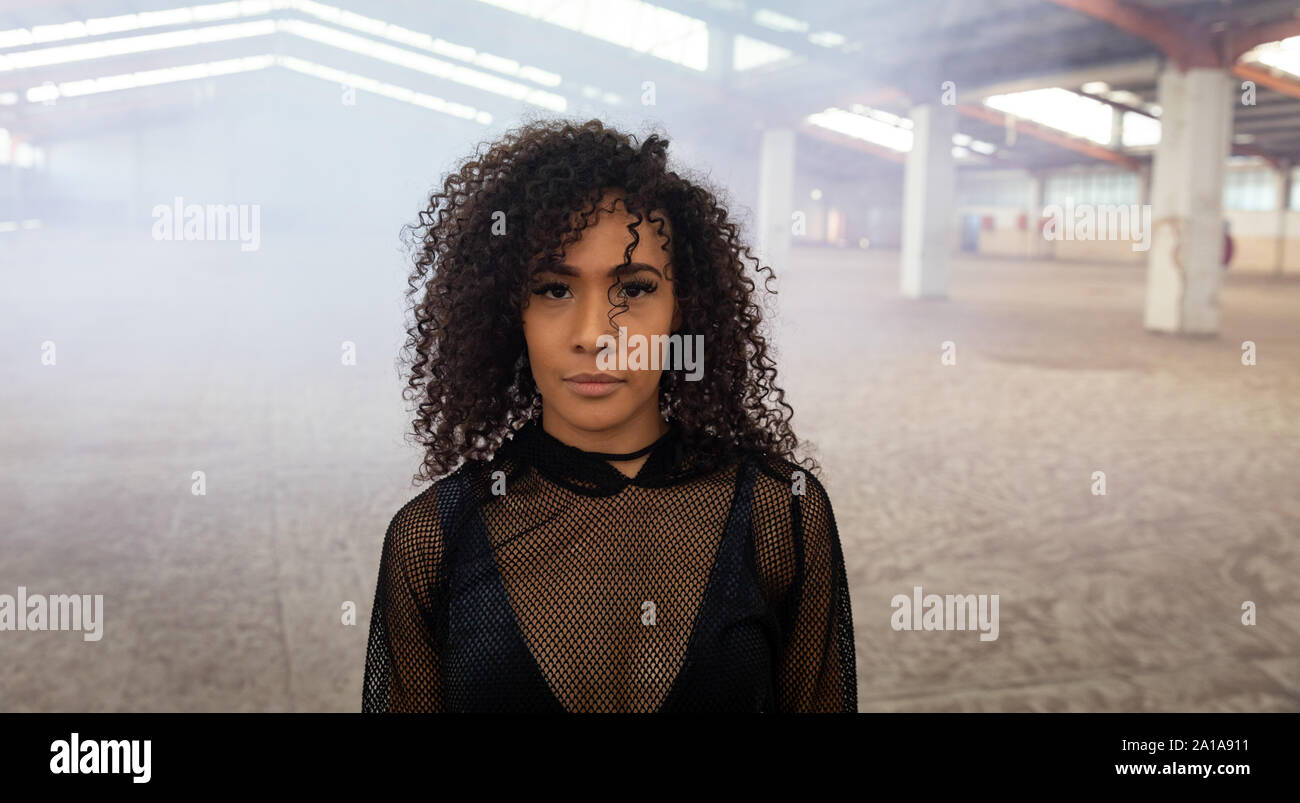Female dancer in an empty warehouse Stock Photo