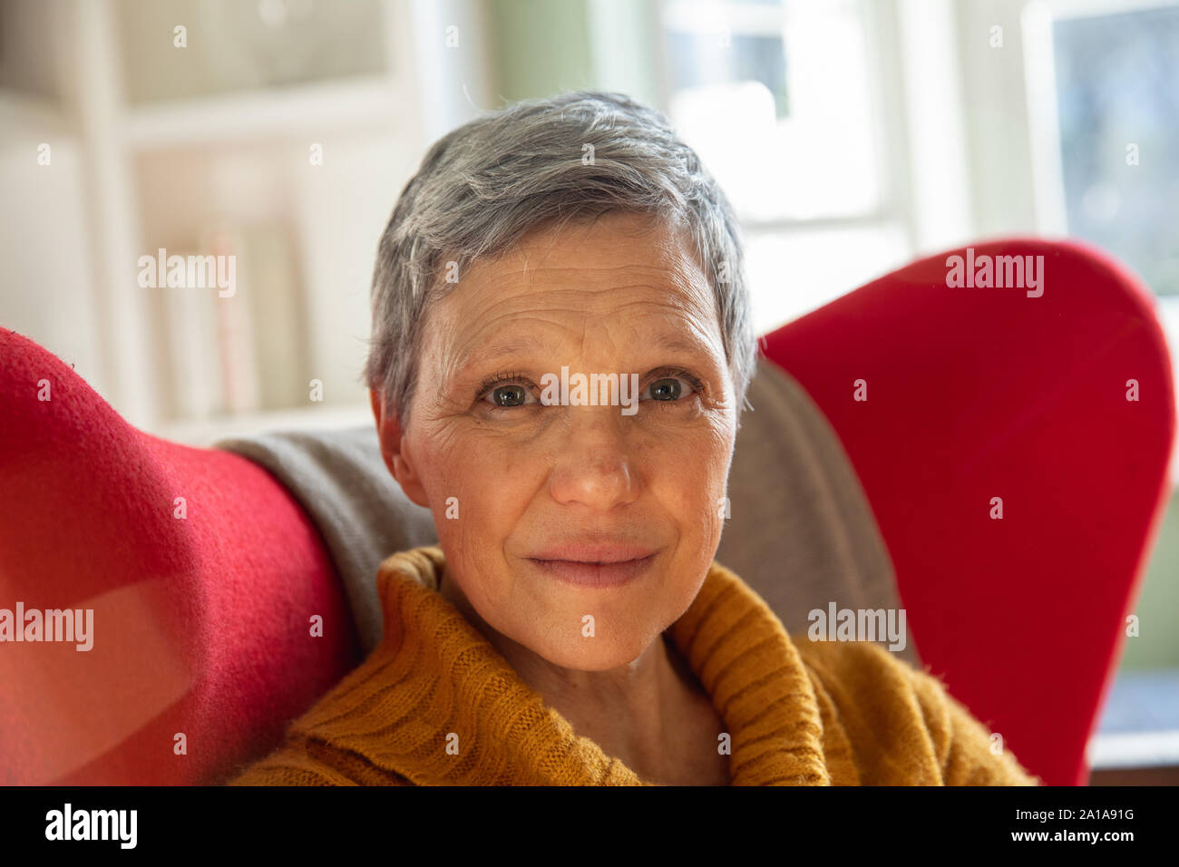 Portrait of a mature woman alone at home Stock Photo