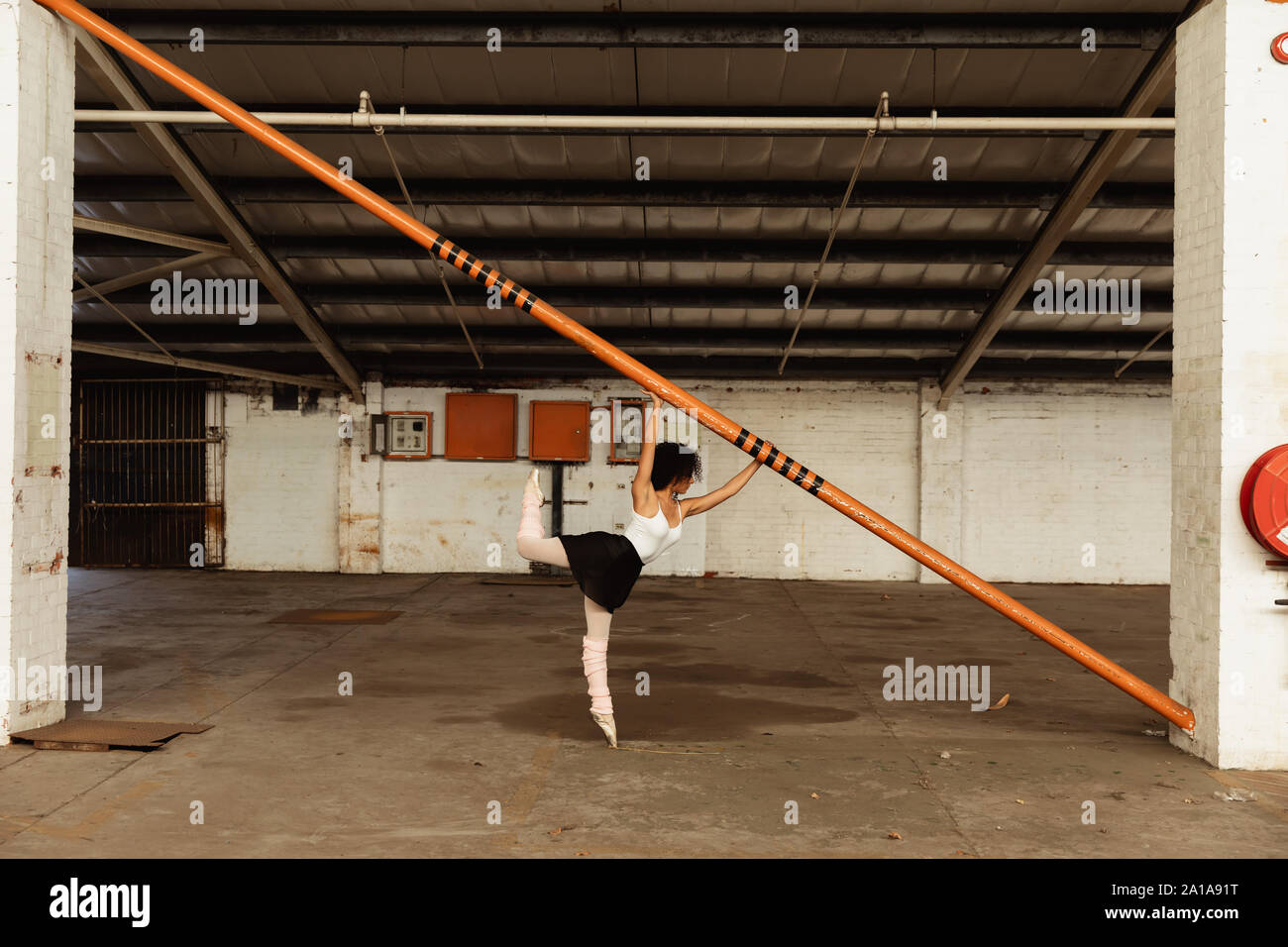 Female dancer in an empty warehouse Stock Photo