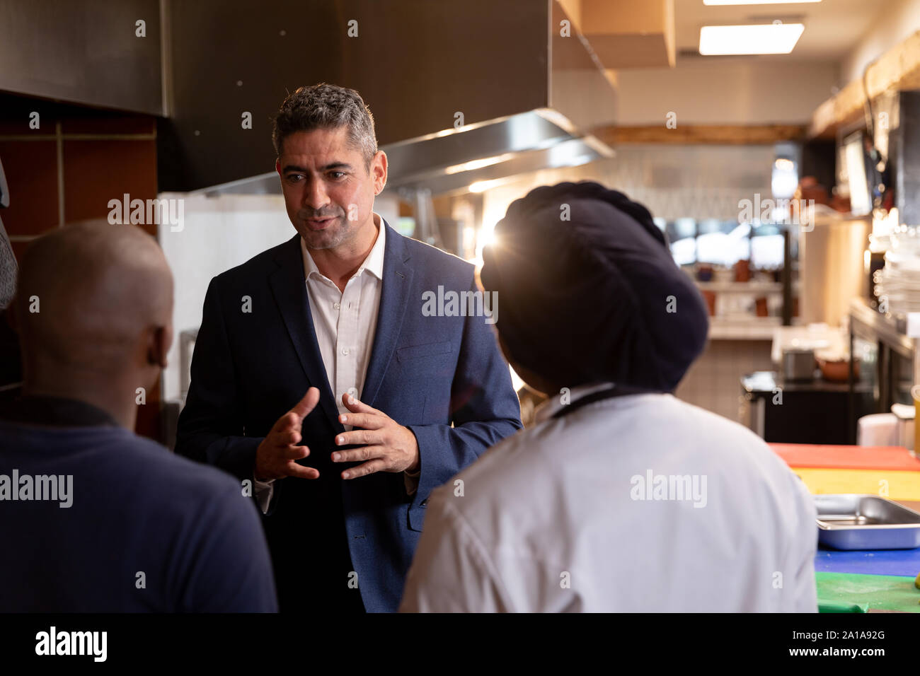 Manager talking to staff in restaurant Stock Photo