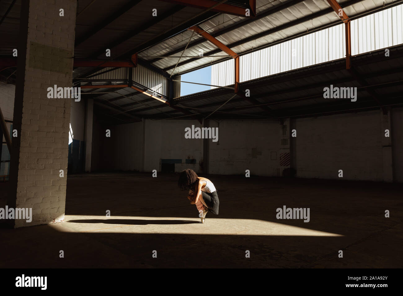 Female dancer in an empty warehouse Stock Photo