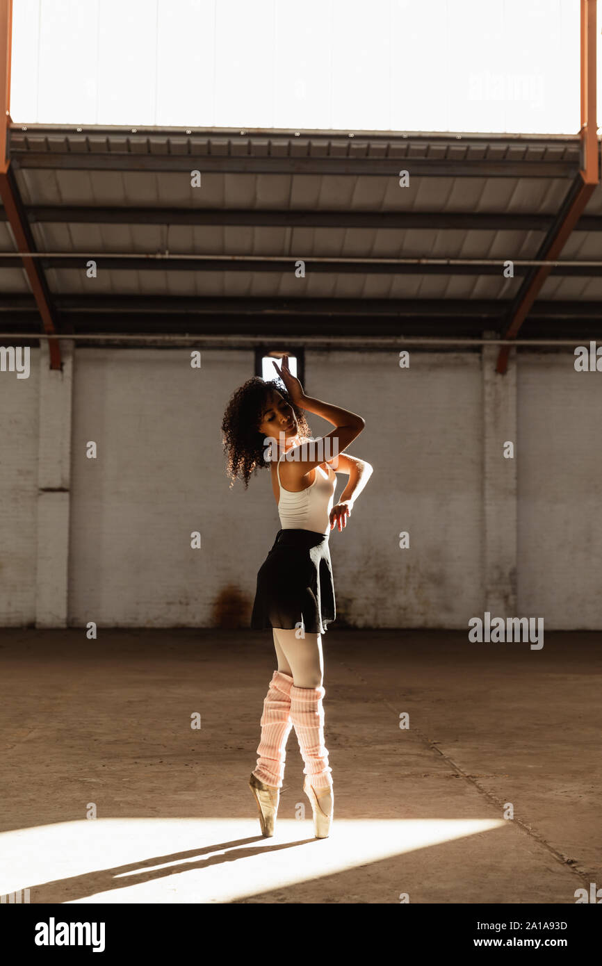 Female dancer in an empty warehouse Stock Photo