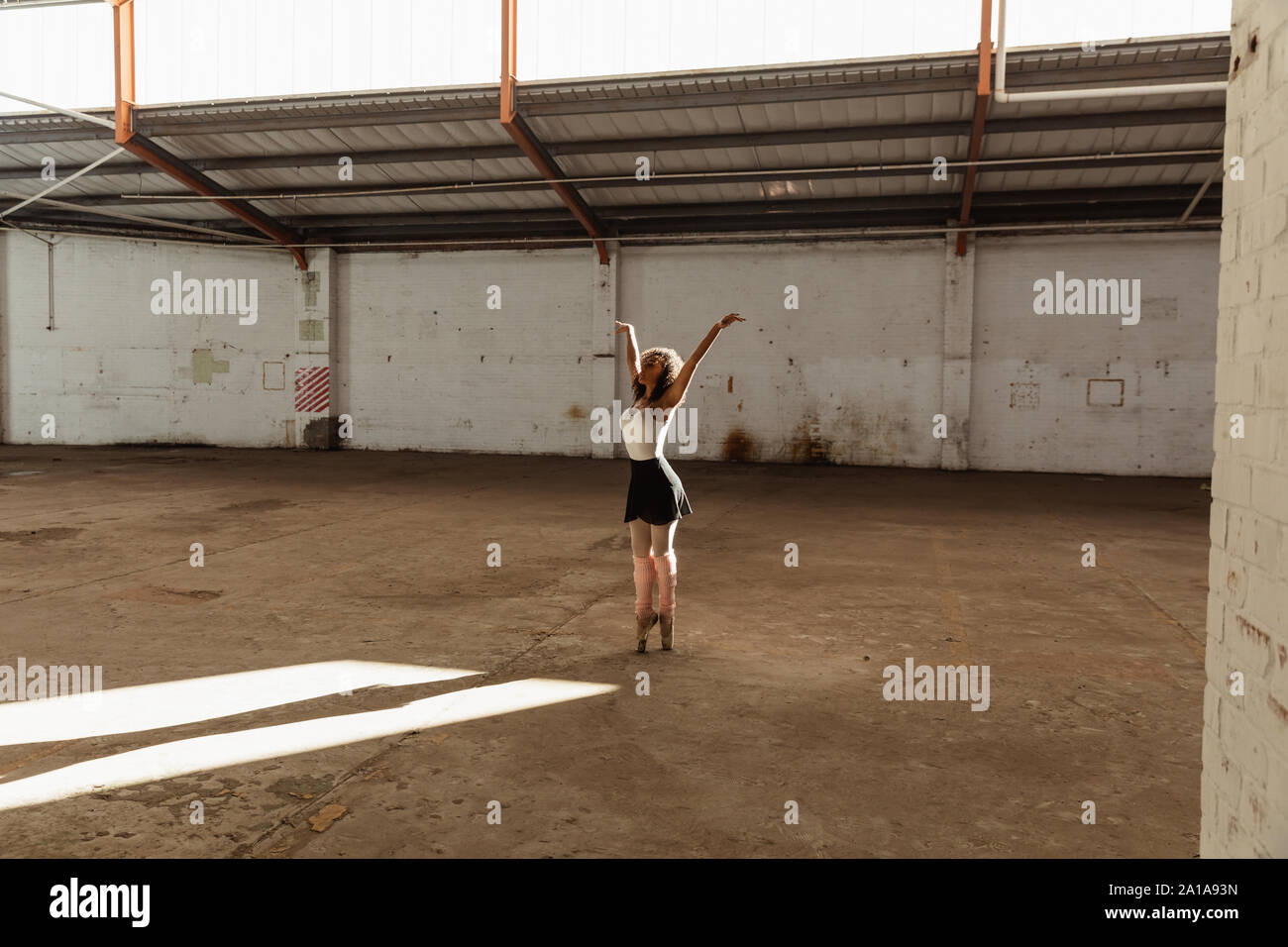 Female dancer in an empty warehouse Stock Photo