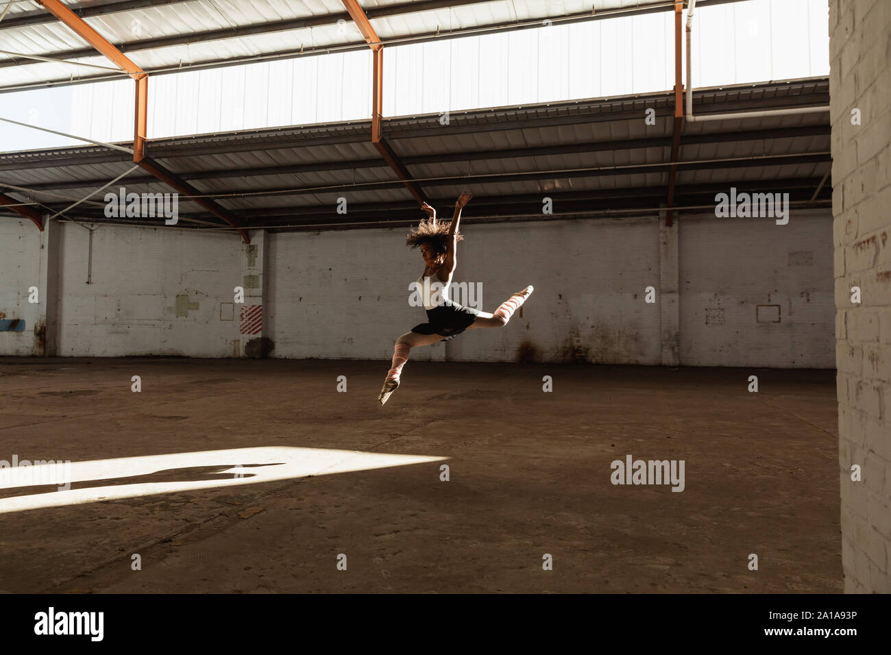 Female dancer in an empty warehouse Stock Photo