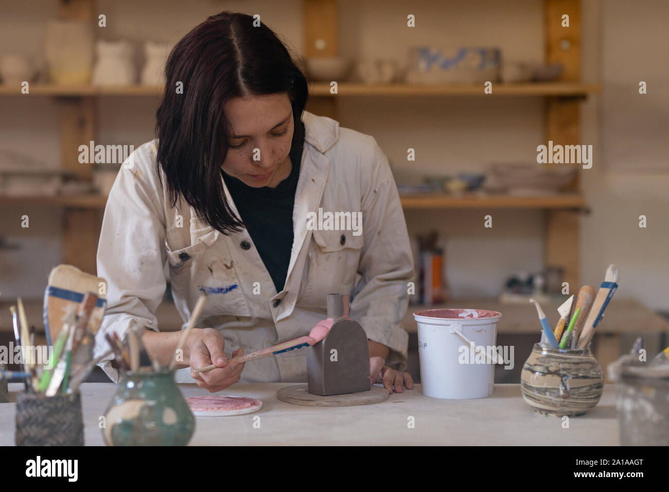 Female potter at work in a pottery studio Stock Photo