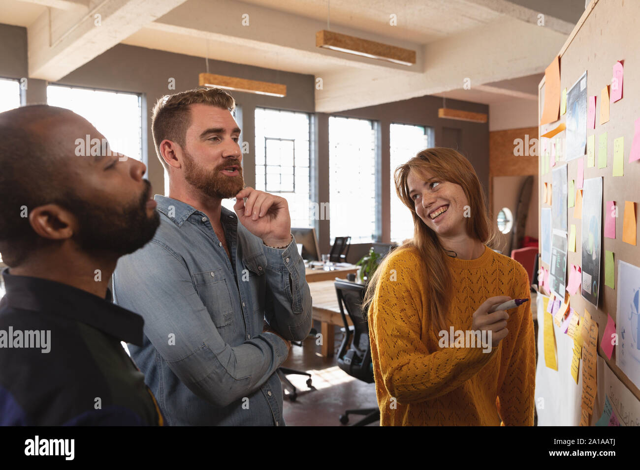 Young creative professionals working in a sunlit office Stock Photo