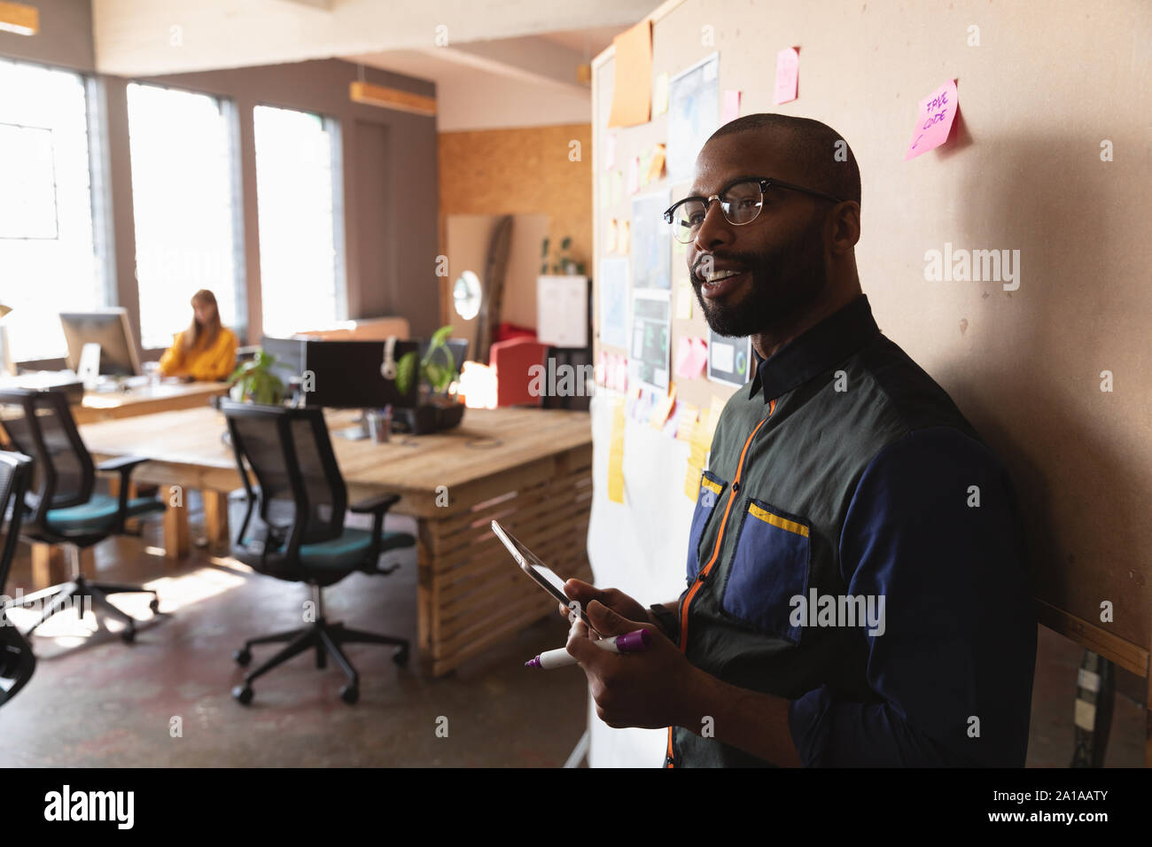 Young creative professional man working in a sunlit office Stock Photo