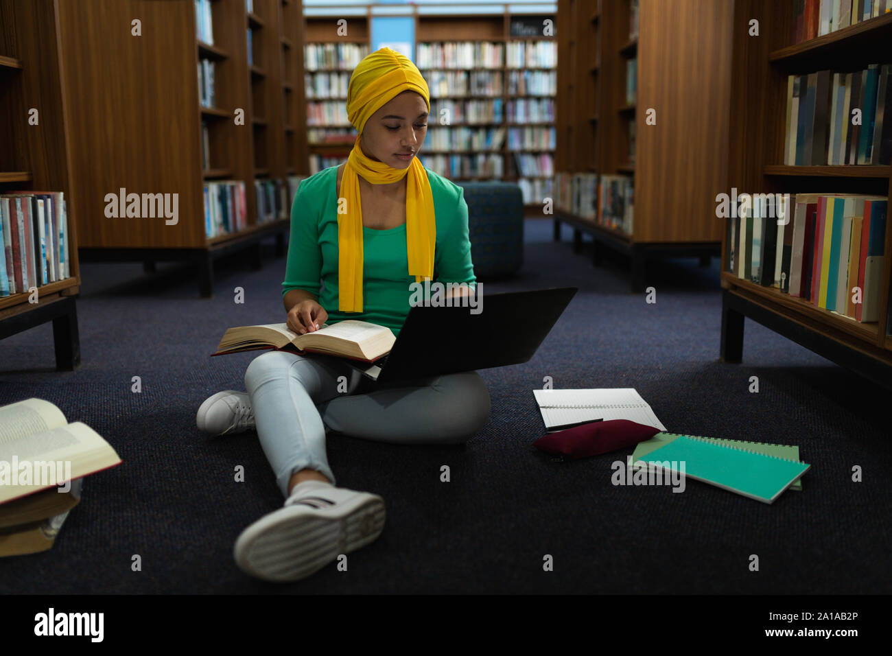 Young woman studying in library Stock Photo