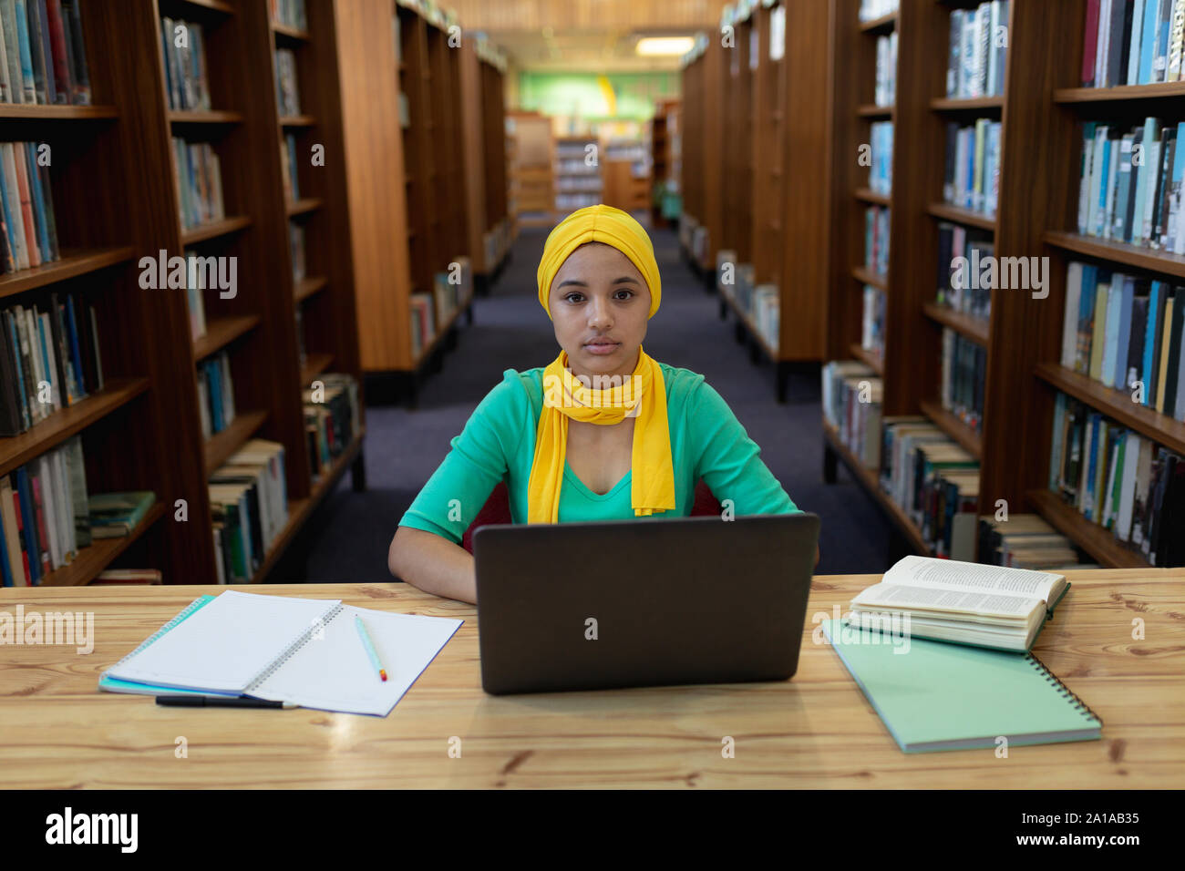 Young woman studying in library Stock Photo