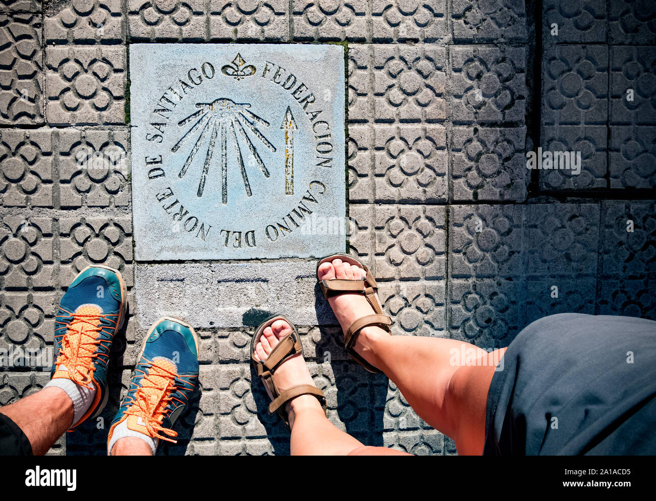 Pilgrimage at the Camino de Santiago. Sign shells and yellow arrow for ...