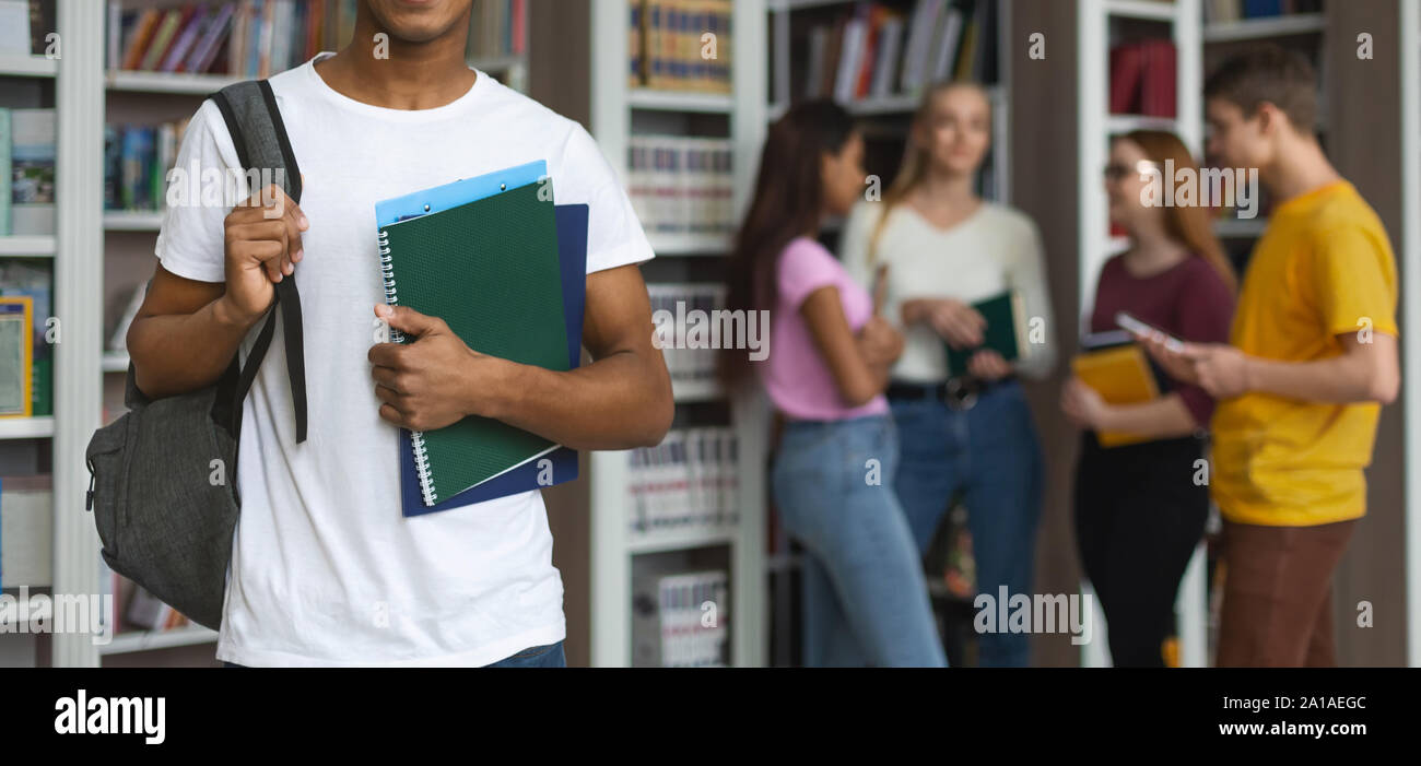 Black student standing in front of group of other students Stock Photo