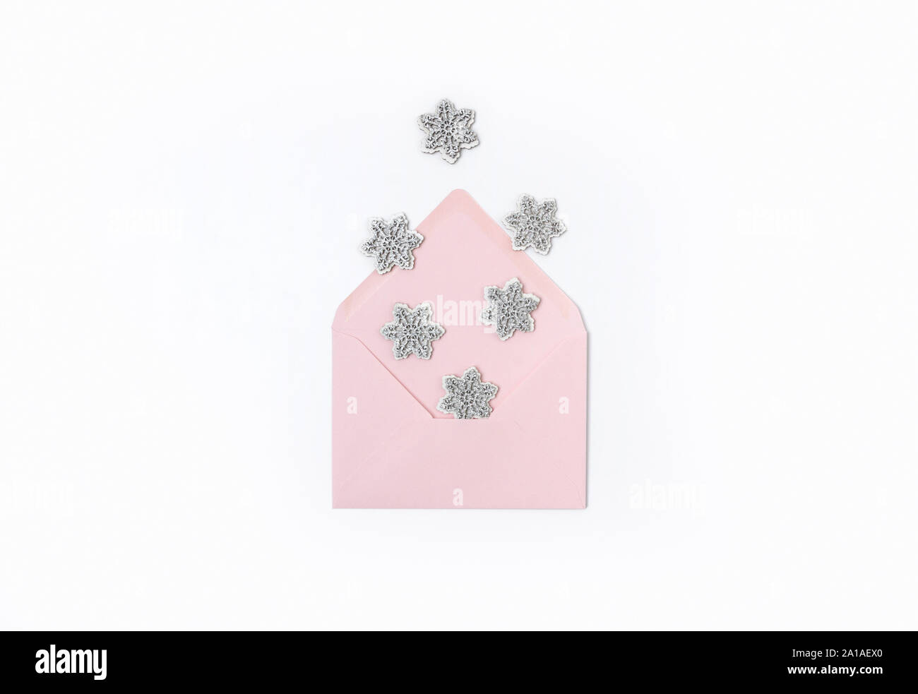 Pink envelope with snowflakes isolated on white background Stock Photo