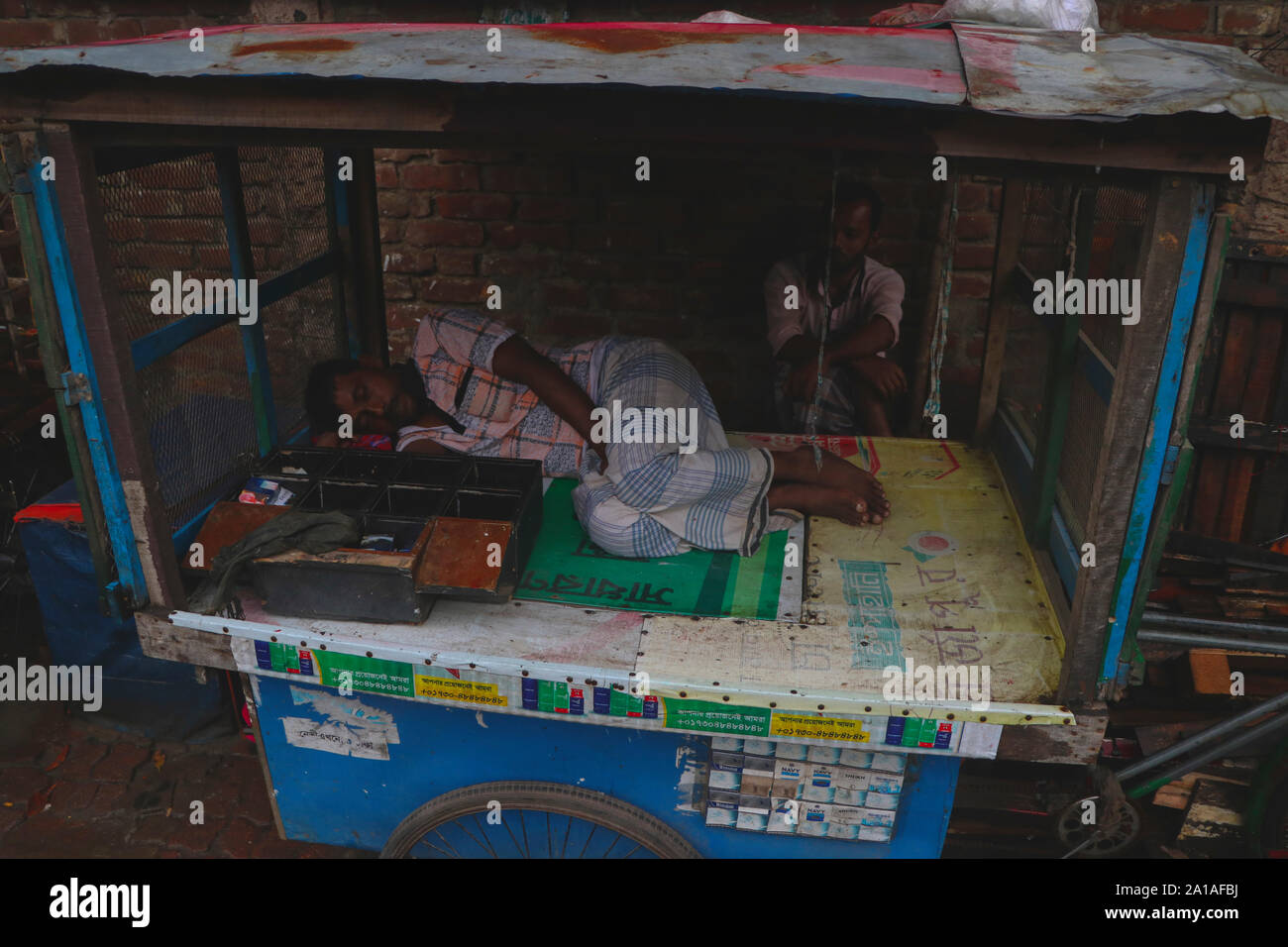 bangladeshi  shopkeepe 25sep2019.On a wet day, the shopkeeper sleeps peacefully© Nazmul Islam / alamy live news Stock Photo