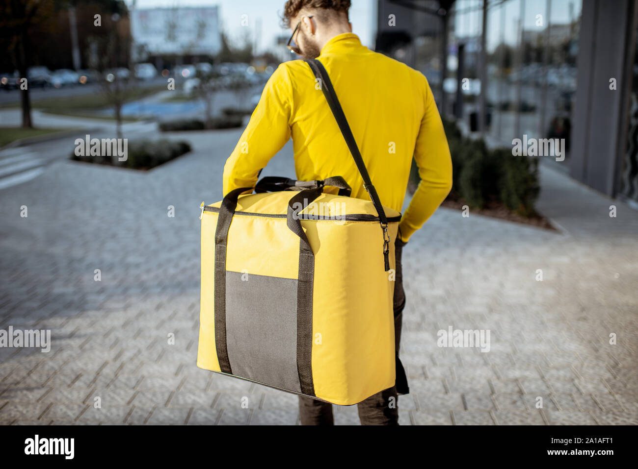 Download Courier Carrying Yellow Thermal Bag Delivering Food In The City Close Up View With Copy Space Delivery Service Concept Stock Photo Alamy Yellowimages Mockups