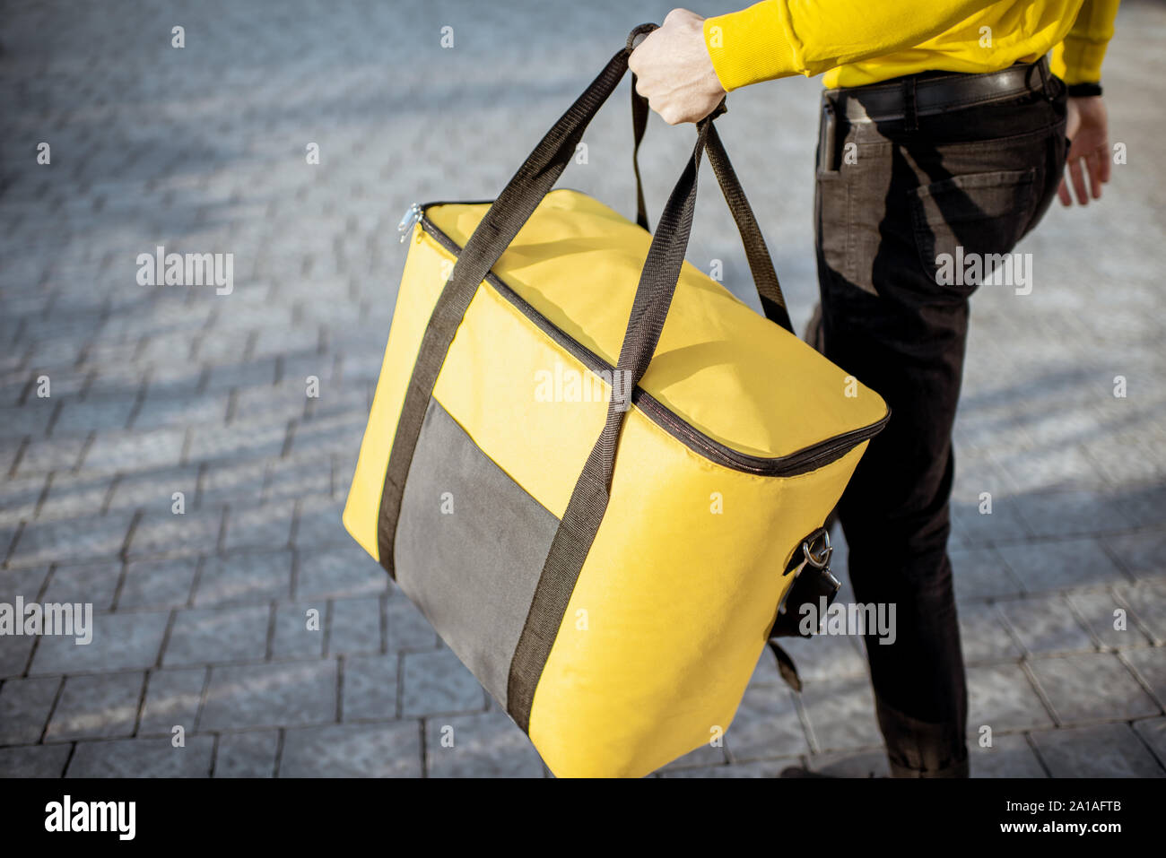 Download Courier Carrying Yellow Thermal Bag Delivering Food In The City Close Up View With Copy Space Delivery Service Concept Stock Photo Alamy PSD Mockup Templates