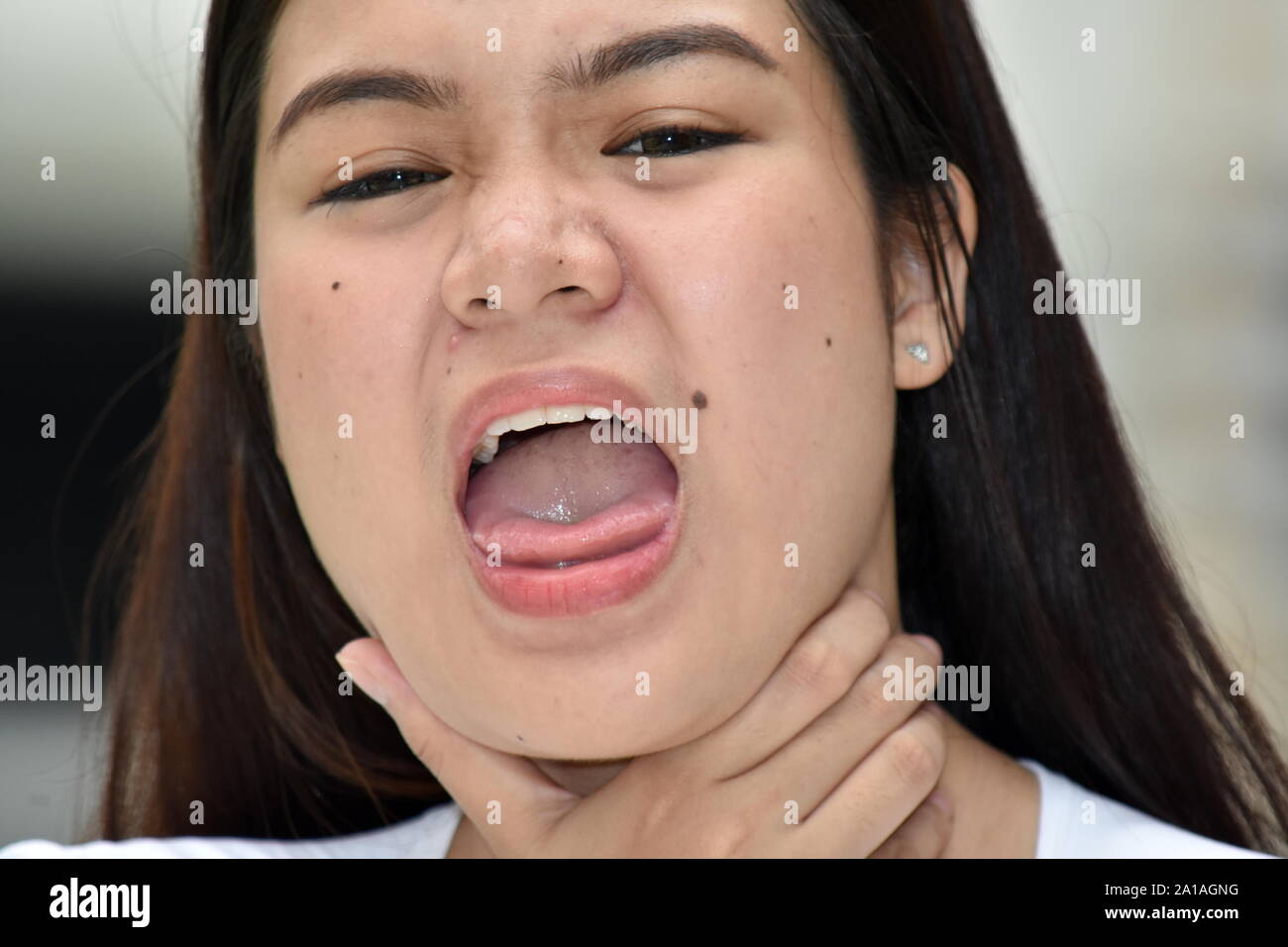 A Young Female Choking Stock Photo