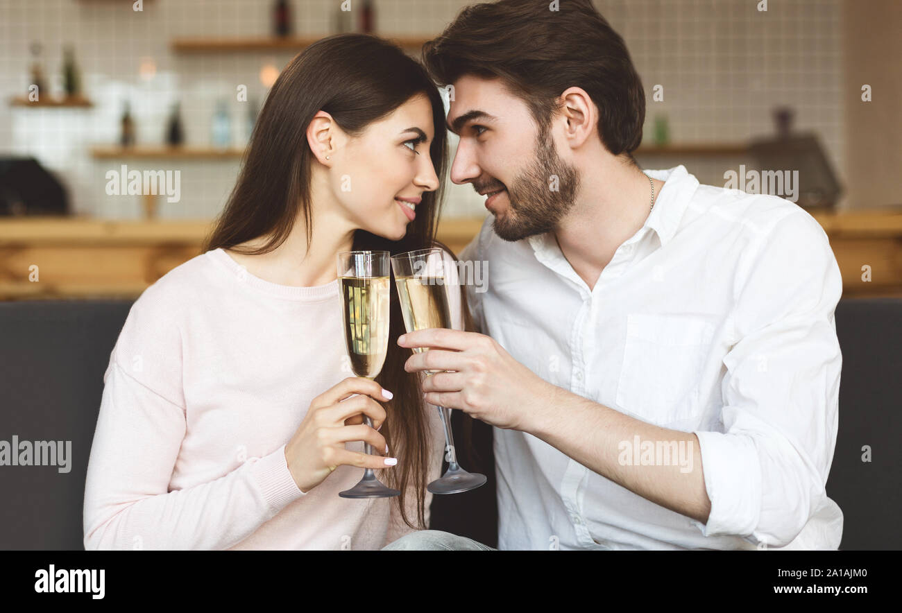 Falling in love couple drinking champagne and looking at each other Stock Photo