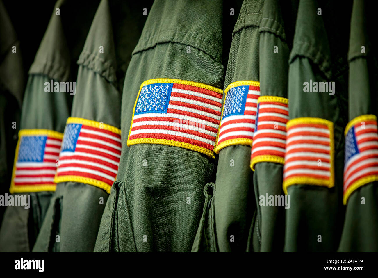 Flight suits in row hanging with American flags on the sleeves Stock Photo