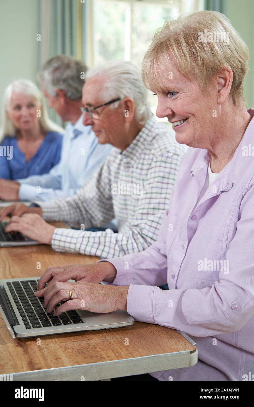 Senior Woman With Tutor In Computer Class Stock Photo