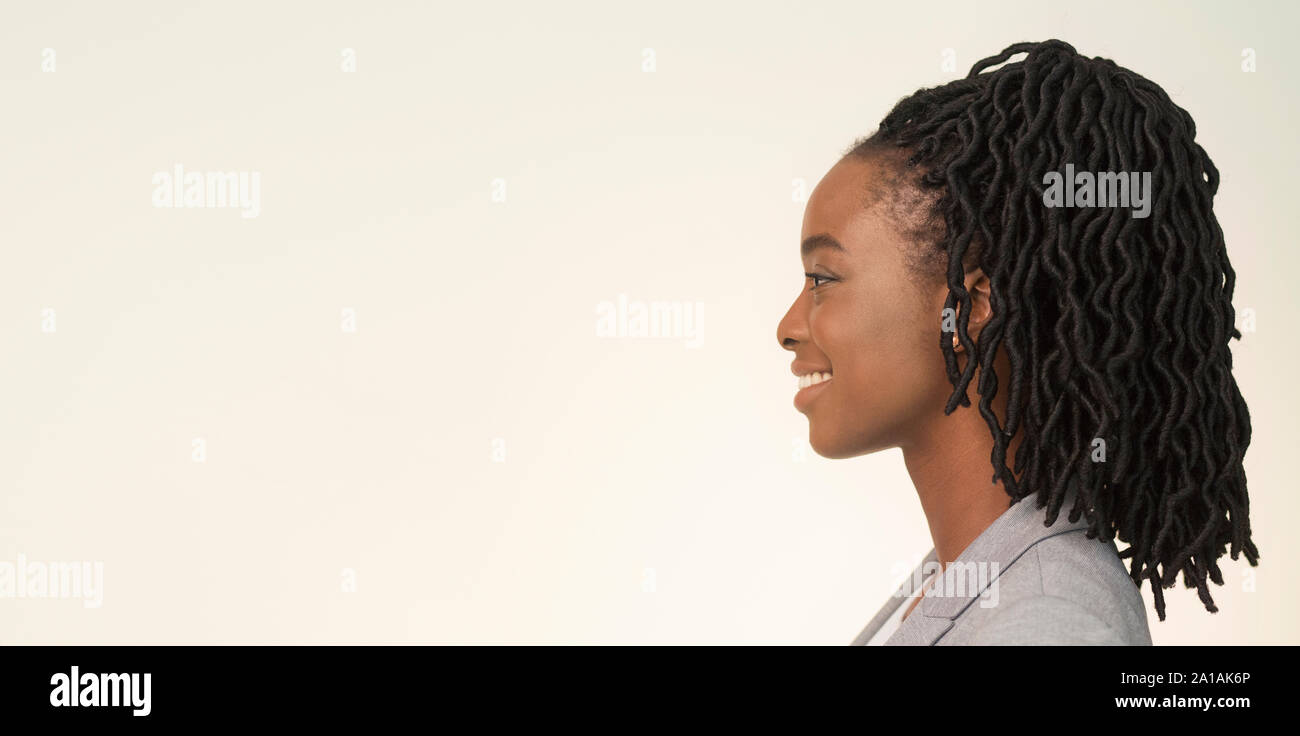 Studio Portrait Of Smiling African American Businesswoman, Side View, Panorama Stock Photo
