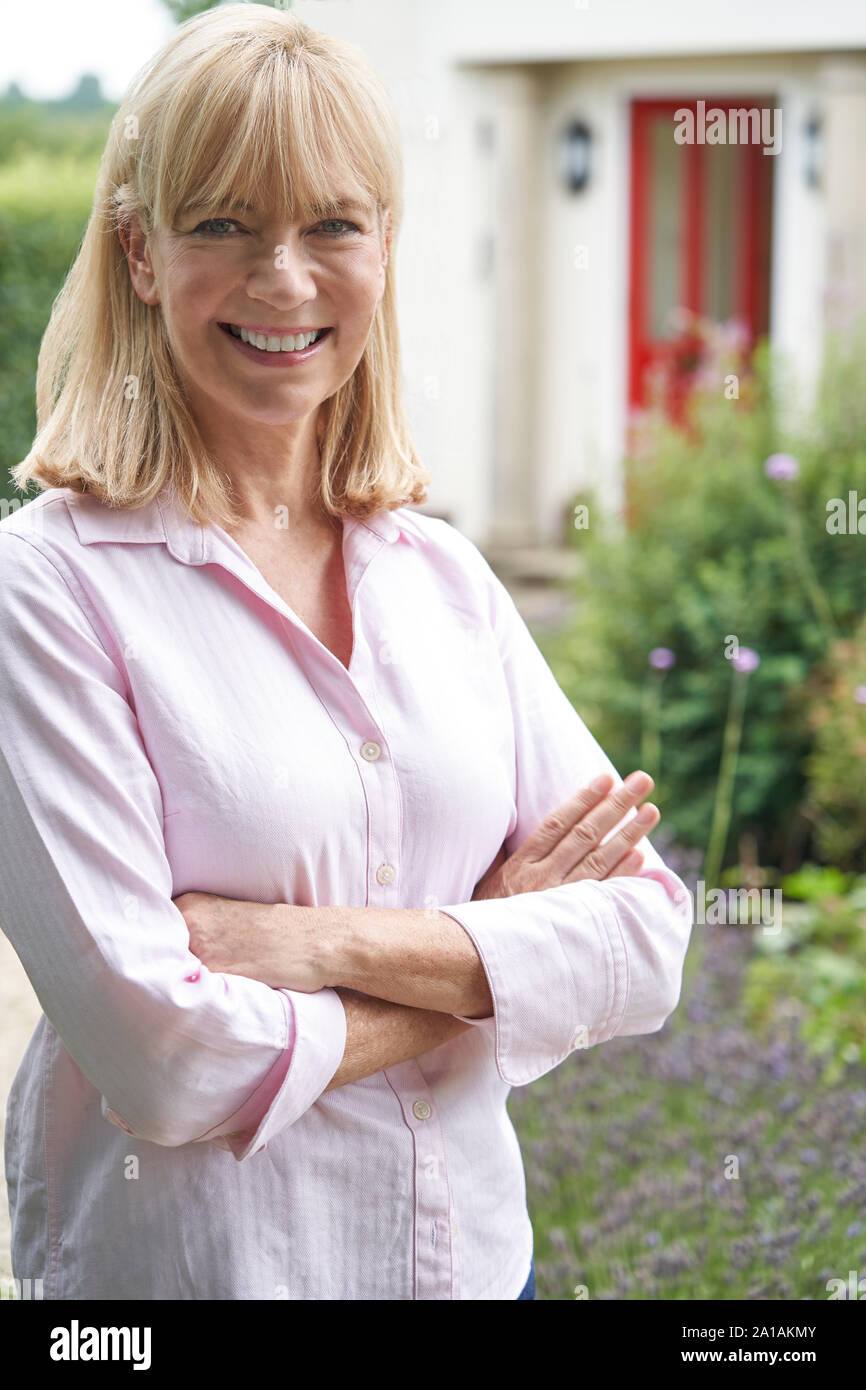 Mature woman home standing smiling hi-res stock photography and images ...