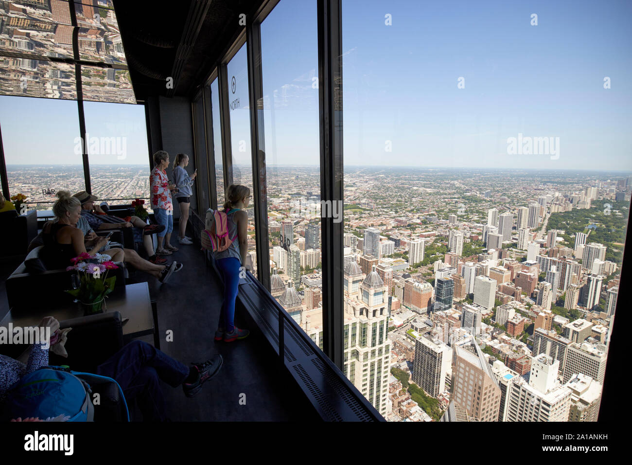 tourists looking out of the windows of the deck observation area of 360 chicago the john hancock center chicago illinois united states of america Stock Photo