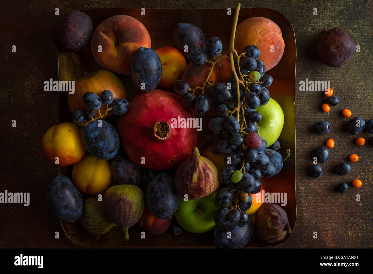 Variety Of Colourful Autumn Fruits Pomegranate Grapes Peaches Plums Apples Figs On Square Platter On Dark Background Horizontal Image Top View Stock Photo Alamy