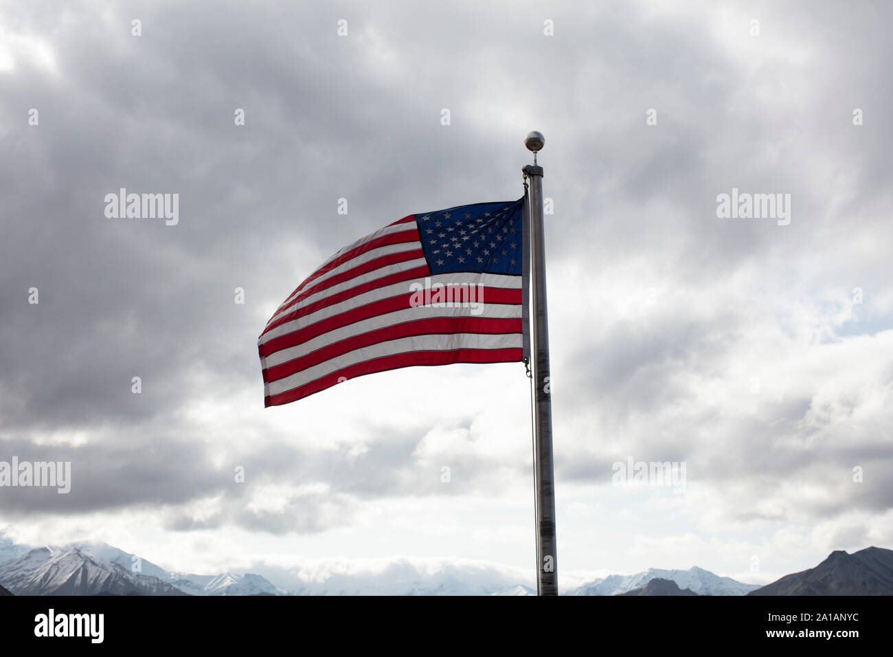US Banner in the wind, cloudy sky Stock Photo