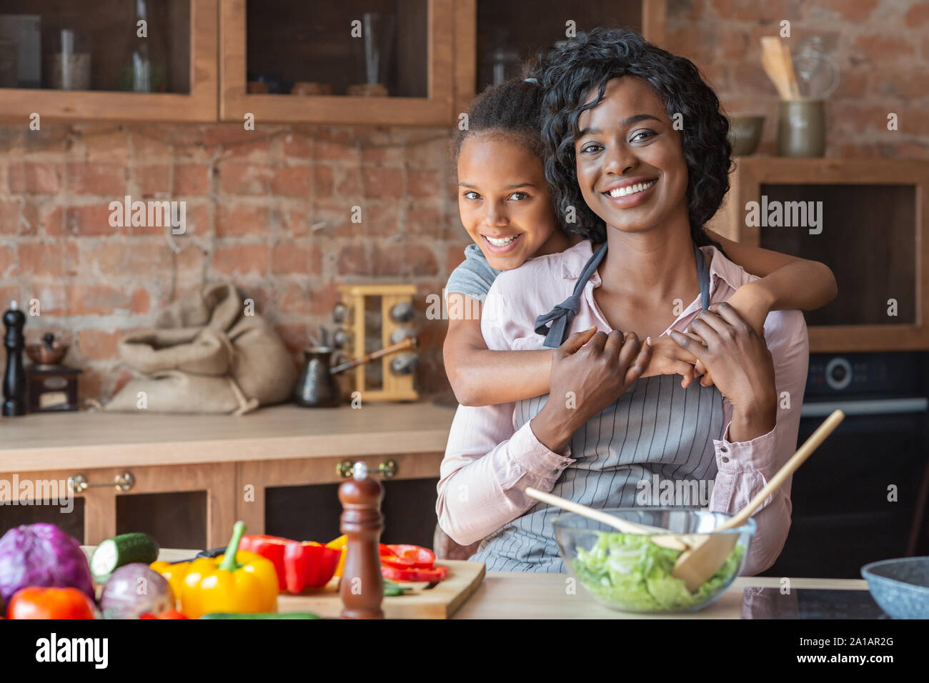 Mother cooking dinner on kitchen with her little cute kid Stock Photo -  Alamy