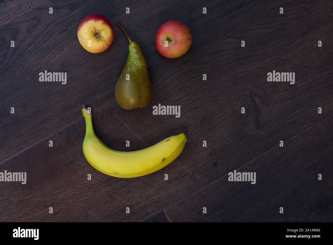 fruit emoji happy smile on wooden surface floor Stock Photo