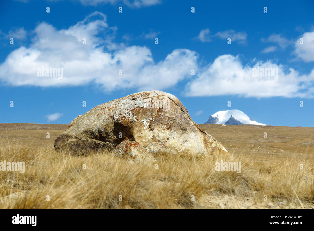 A big stone and a mountains peak. Stock Photo