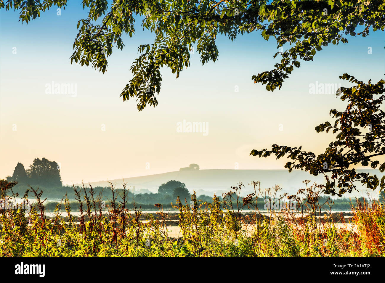 The view towards Liddington Hill near Swindon, Wiltshire on an early autumn sunrise. Stock Photo