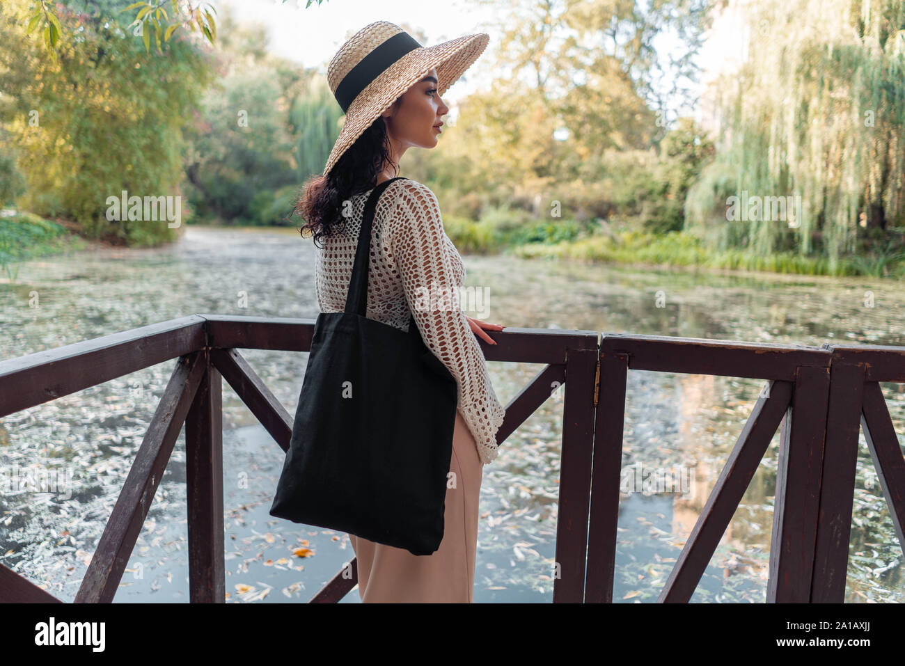 straw hat with black blank bag outdoors 