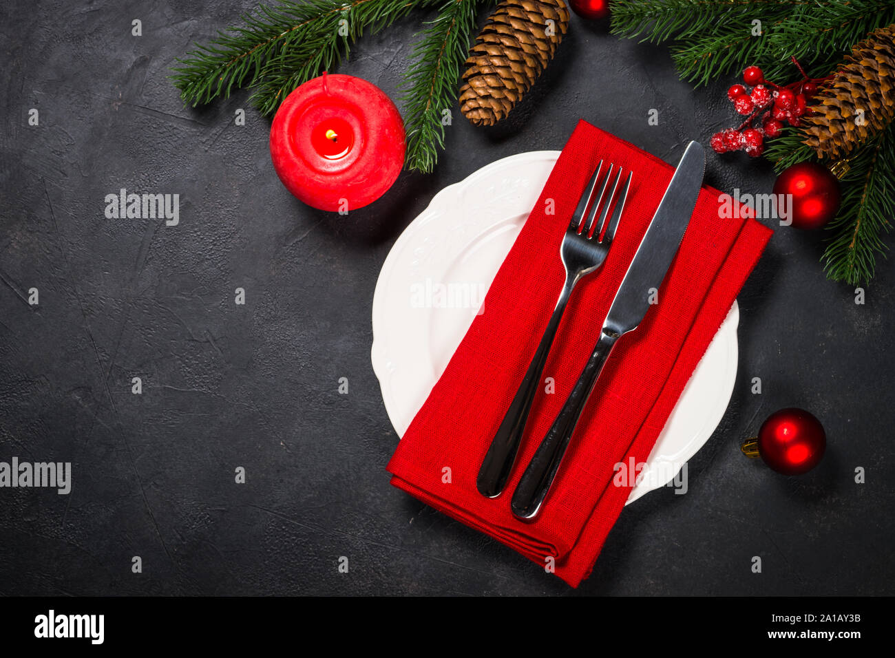 Christmas table setting on black Stock Photo - Alamy