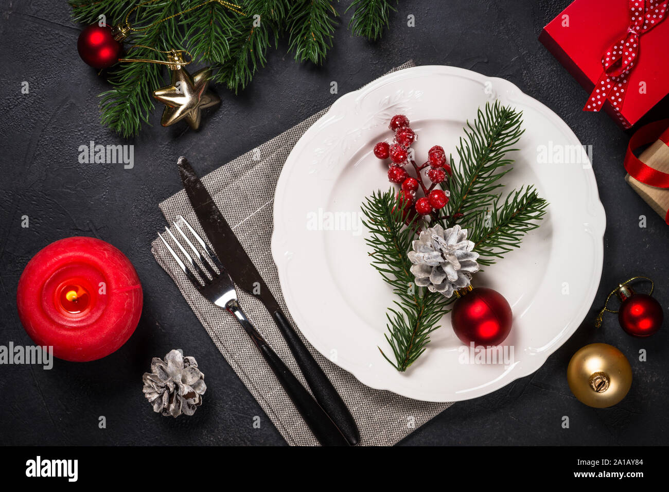Christmas table setting on black Stock Photo - Alamy