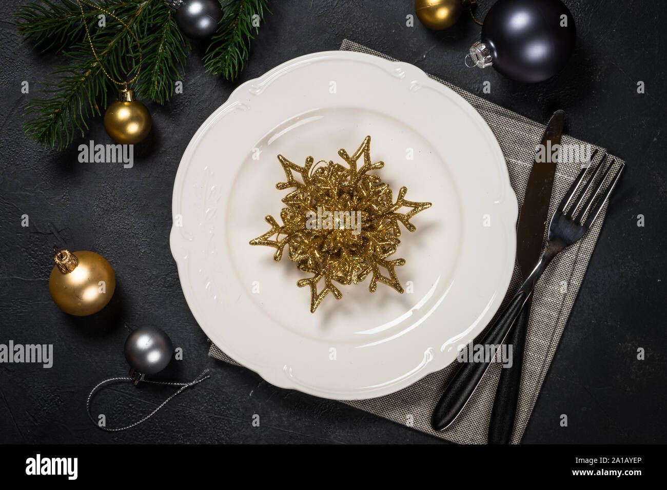 Christmas table setting on black Stock Photo - Alamy