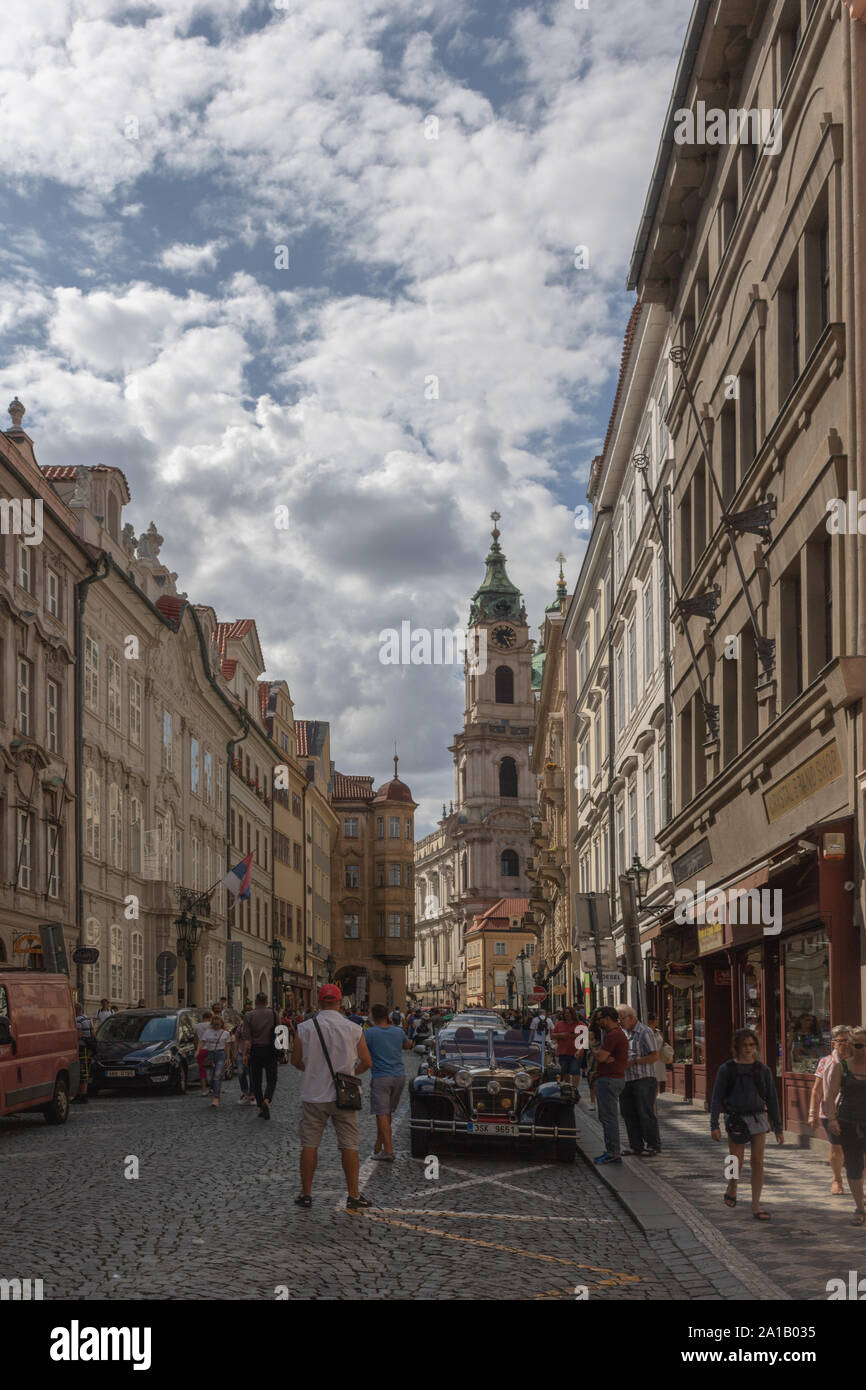 Mostecká street heading toward Malostranské náměstí and St. Nicholas Church in Prague, Czech Republic. Stock Photo