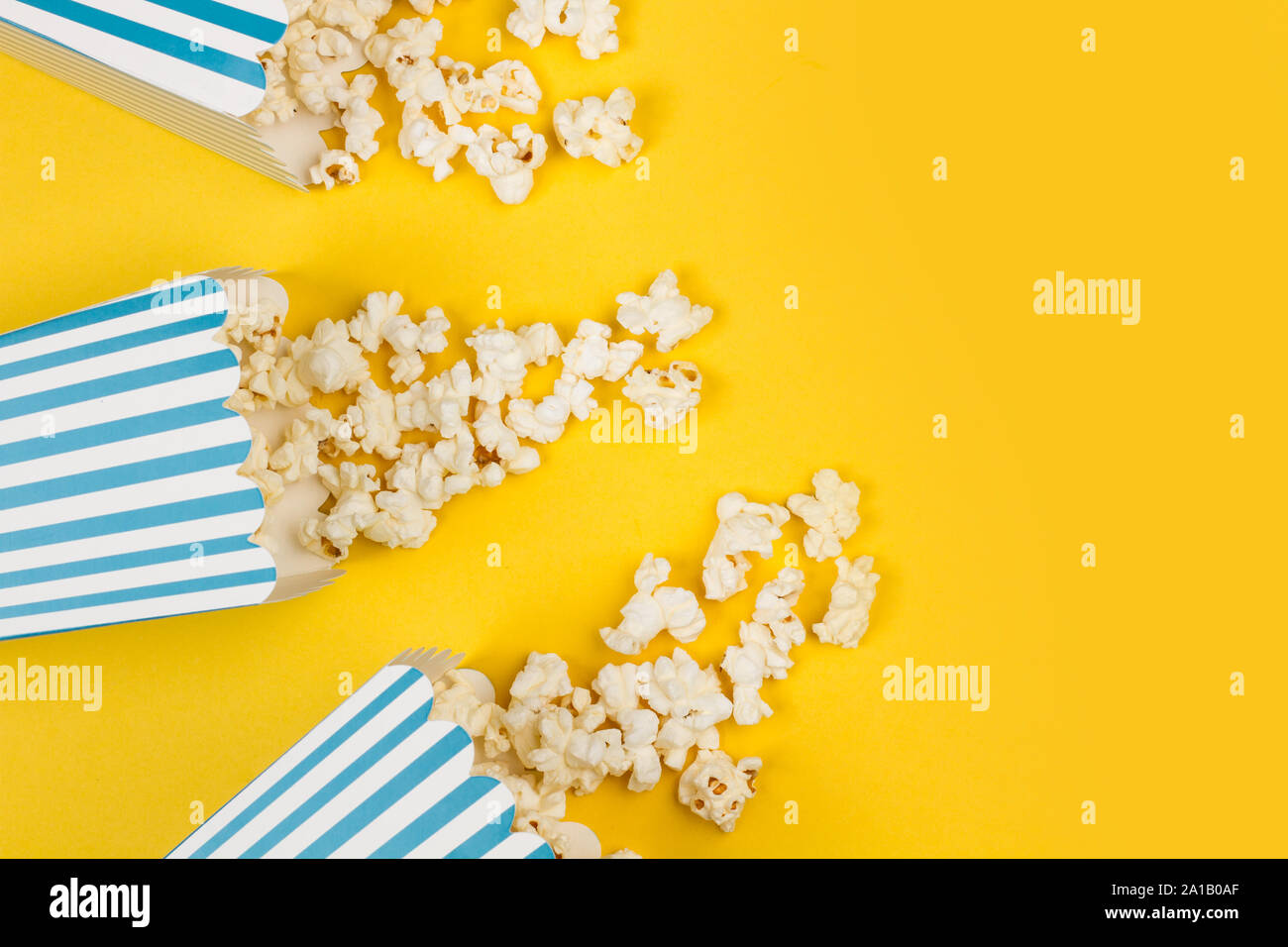 Popcorn in buckets on a yellow background Stock Photo