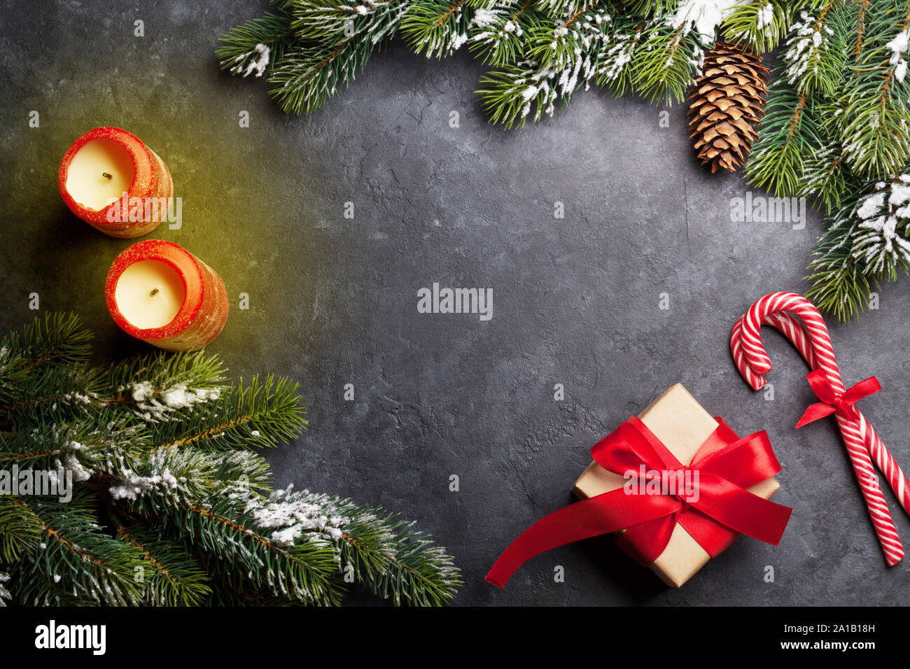 Christmas card with candles and fir tree branch covered by snow on ...
