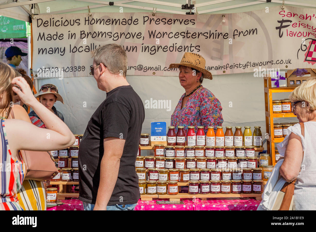 Locally grown preserves are neatly stacked in jars and offered for sale on a stall at Belbroughton Scarecrow Festival. Stock Photo