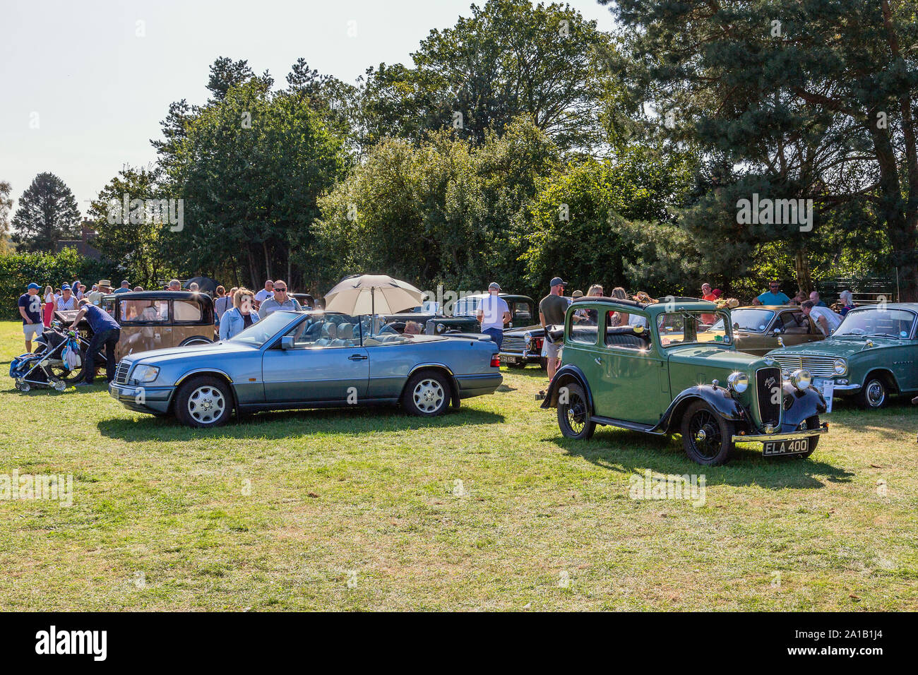 Visitors enjoying a showing of Classic and Vintage cars at the Belbroughton Scarecrow Festival, Worcestershire, England, UK. Stock Photo