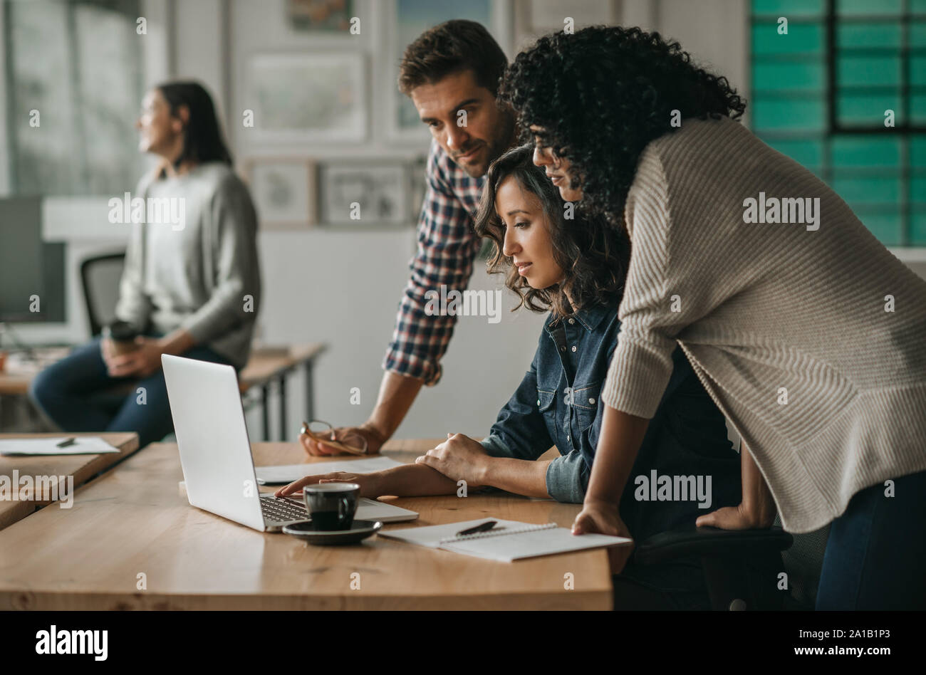 Diverse group of designers working together on an office laptop Stock Photo