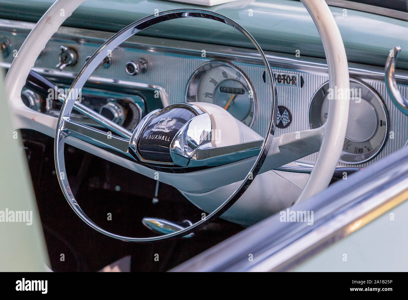 The beautiful mint green interior of a vintage Vauxhall Victor FB, showing the steering wheel indicator arm and dashboard. Stock Photo