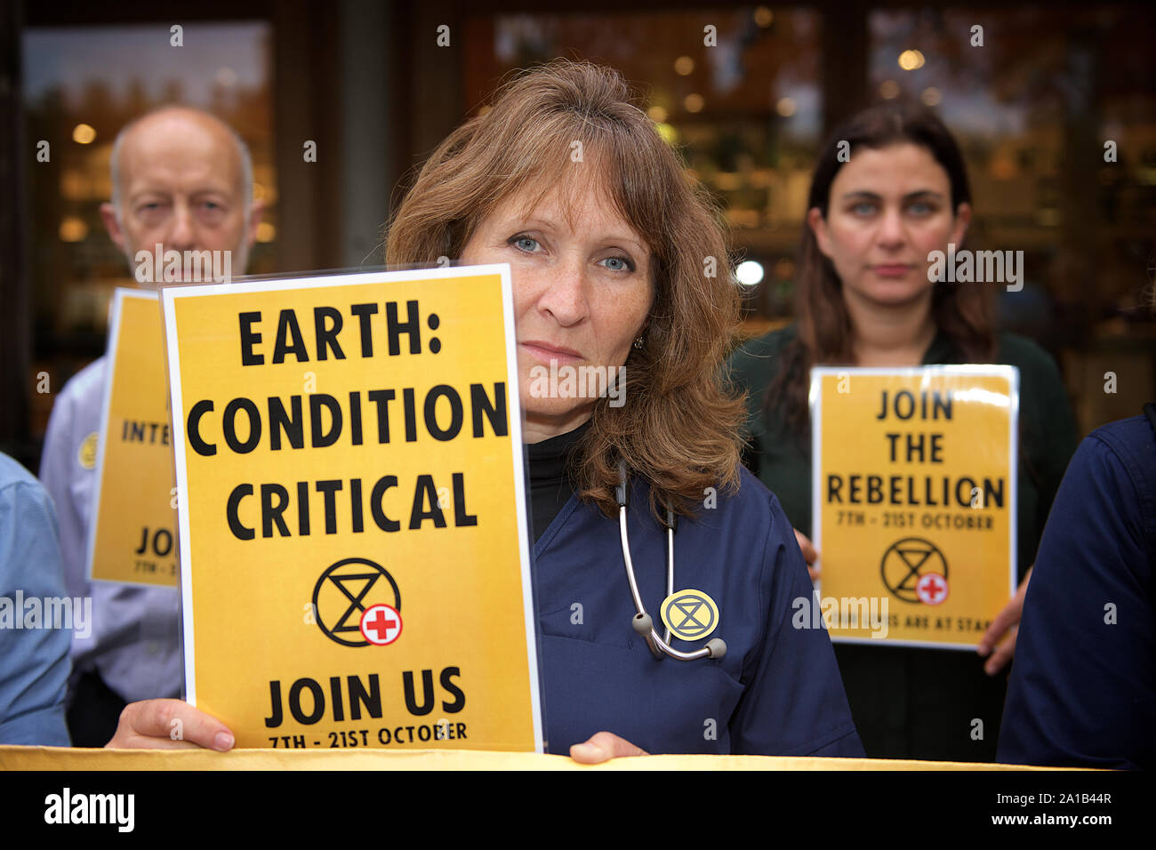 London, UK. 25th September, 2019. Doctors protesting with Extinction Rebellion glued themselves to a government building to protest against the threat of climate change on global health. This group of doctors & health professionals are calling for action to the 'impending public health crisis arising from climate and ecological breakdown'. Credit Gareth Morris/Alamy Live News Stock Photo