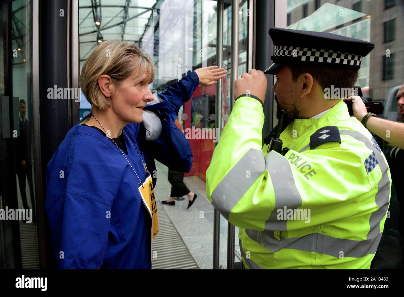 London, UK. 25th September, 2019. Doctors protesting with Extinction Rebellion glued themselves to a government building to protest against the threat of climate change on global health. This group of doctors & health professionals are calling for action to the 'impending public health crisis arising from climate and ecological breakdown'. Credit Gareth Morris/Alamy Live News Stock Photo