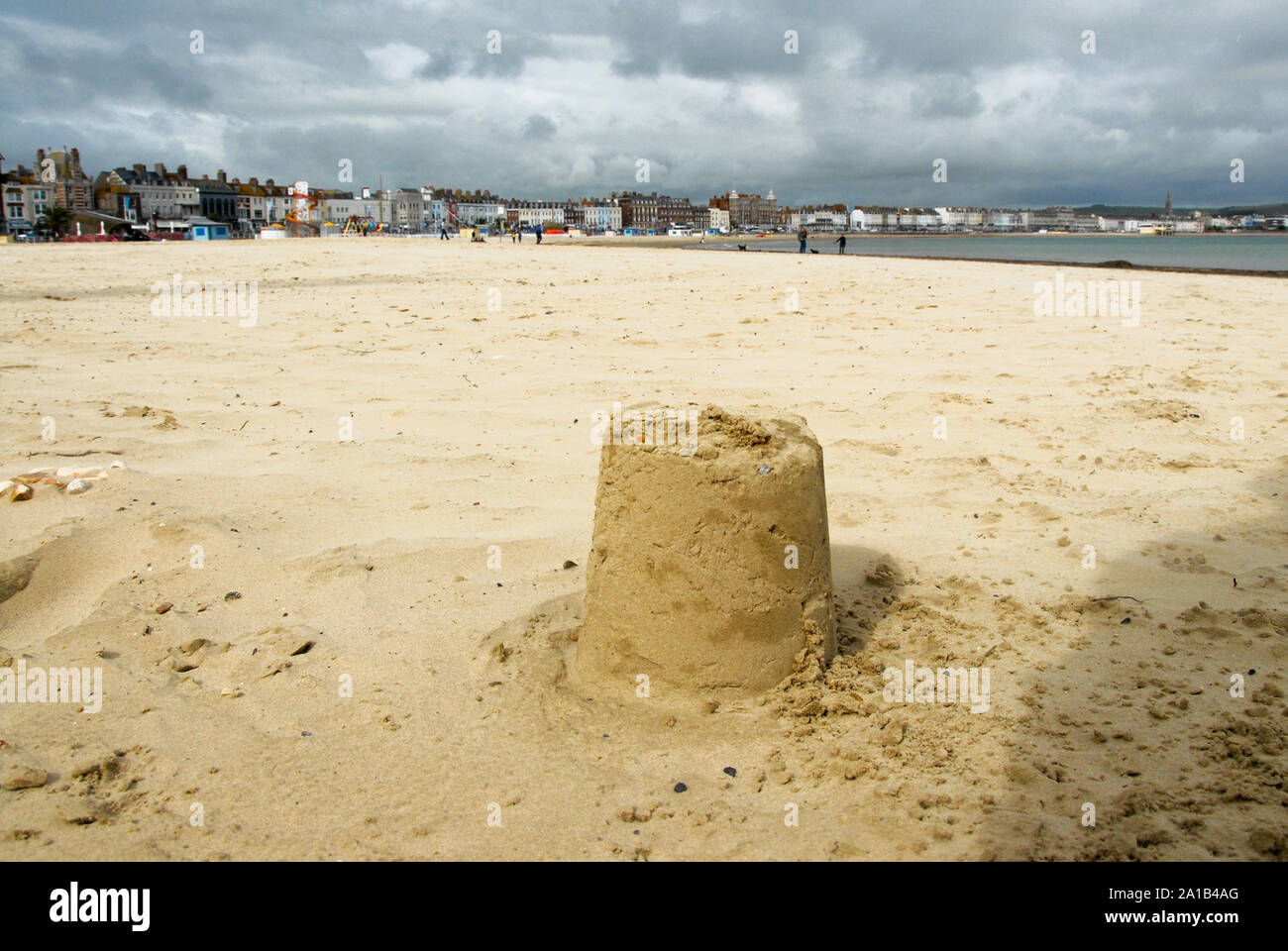 Weymouth. 25th September 2019. UK Weather. A solitary sandcastle sits on Weymouth sands, under threatening storm clouds. credit: stuart fretwell/Alamy Live News Stock Photo