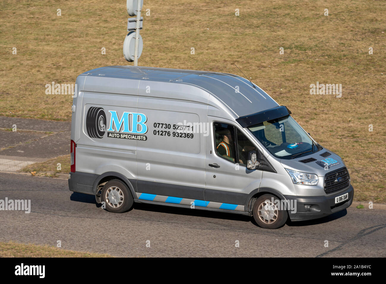 MB Auto Specialists vehicle Ford Transit van driving on the road near Heathrow, London, UK. Transport and logistics company. Space for copy Stock Photo