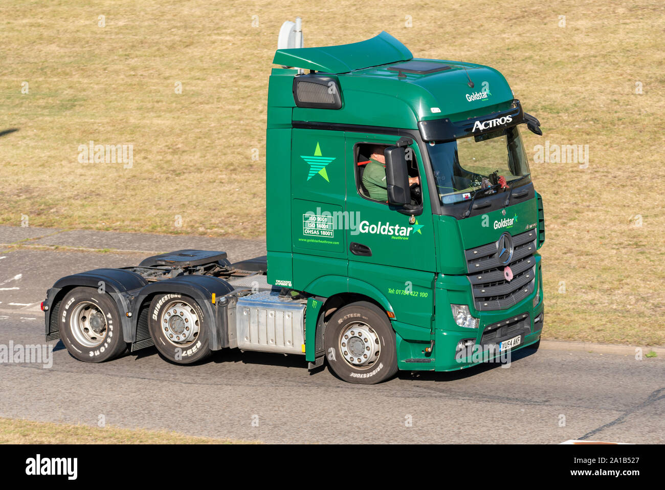 Goldstar Heathrow Mercedes Actros tractor unit vehicle driving on the road near Heathrow, London, UK. Transport and logistics company Stock Photo